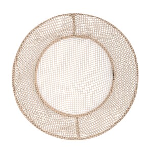 May include: A round, beige, wire mesh basket with a circular opening in the center. The basket is made of a fine wire mesh and has a slightly raised rim.