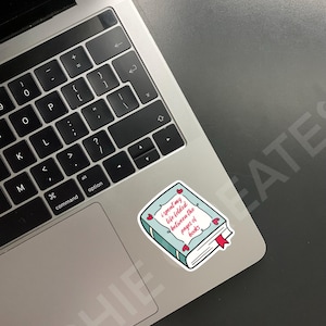May include: A blue book sticker with a red heart design and the text "I spent my life folded between the pages of books".