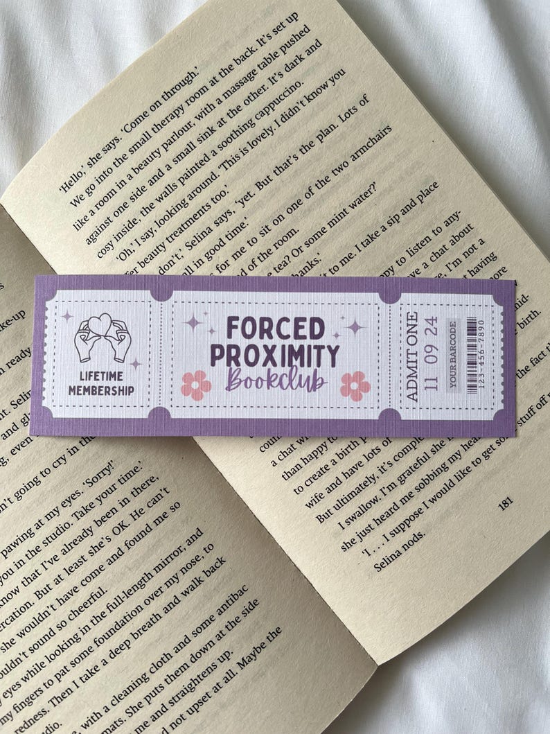 May include: Purple and white bookmark with the text "Forced Proximity Bookclub" and a hand holding a heart. The bookmark also has a barcode and the text "Admit One 11 09 24".