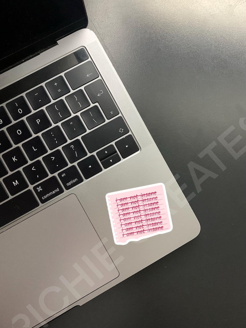 May include: A pink sticky note with the phrase "I am not insane" repeated eight times in a handwritten font.