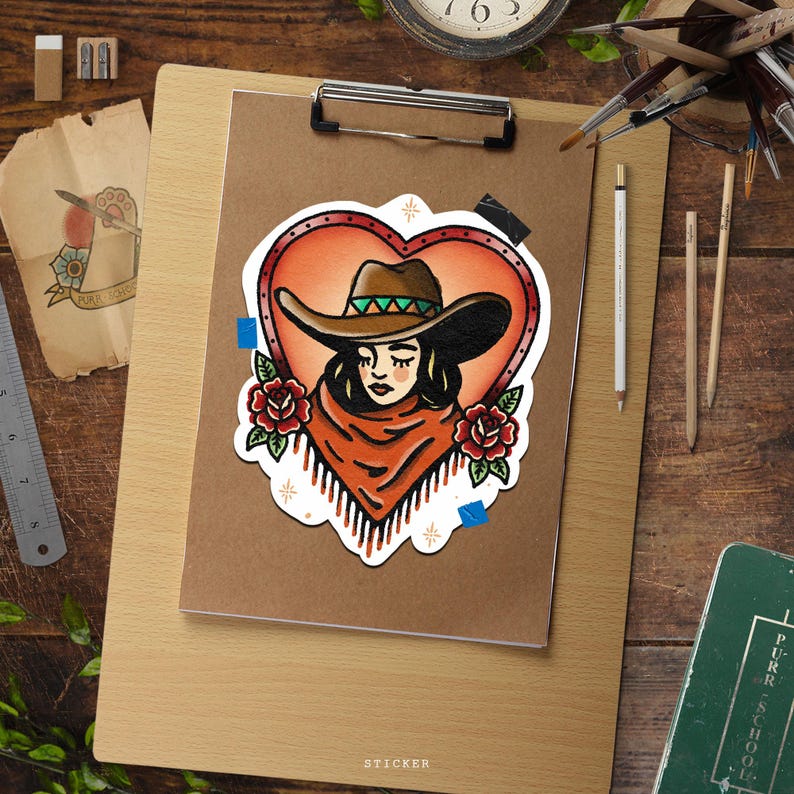 May include: A sticker featuring a cowgirl design within a heart-shaped frame. The cowgirl wears a brown hat with a green band, a fringed orange shawl, and is surrounded by red roses. The word "STICKER" is at the bottom.