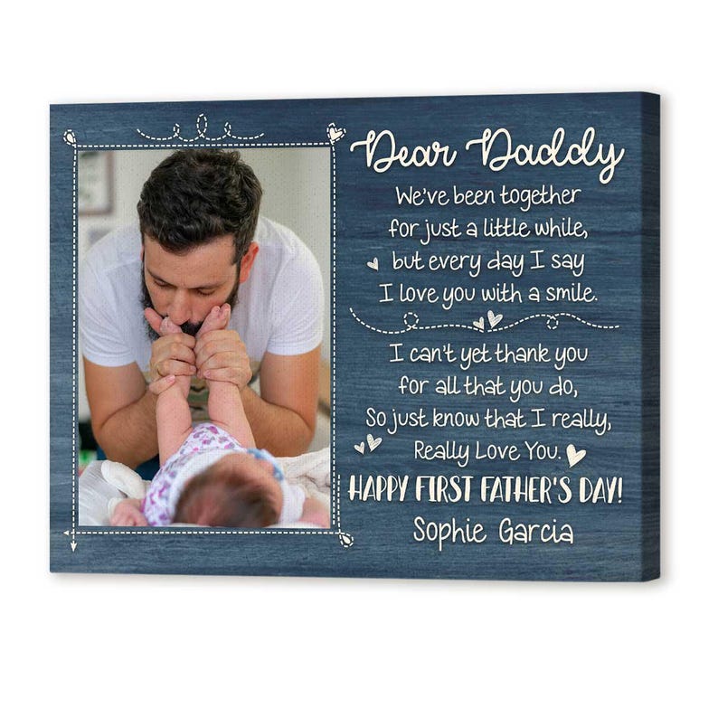 Puede incluir: Placa de madera azul con una foto de un padre y un beb&eacute;, enmarcada con una l&iacute;nea punteada blanca. El texto dice "&iexcl;Feliz D&iacute;a del Padre!" y un mensaje de amor.