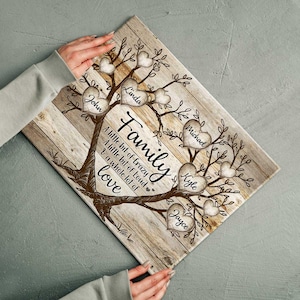 May include: A rustic wooden family tree with brown branches and heart-shaped leaves. Each heart has a name written inside: John, Linda, Michael, Kyle, and Jayce. The text reads "Family, A little bit of crazy, A little bit of loud, & a whole lot of love."