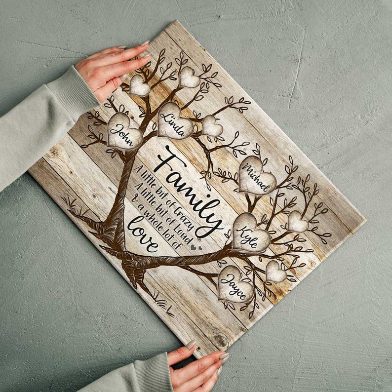 May include: A rustic wooden family tree with brown branches and heart-shaped leaves. Each heart has a name written inside: John, Linda, Michael, Kyle, and Jayce. The text reads "Family, A little bit of crazy, A little bit of loud, & a whole lot of love."