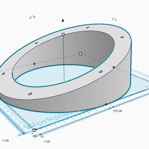 May include: A 3D model of a grey, ring-shaped object with evenly spaced holes. The object is positioned on a blue grid, with dimensions indicated. The height is 63.50 units, and the base is 175.00 units (17.5 cm).