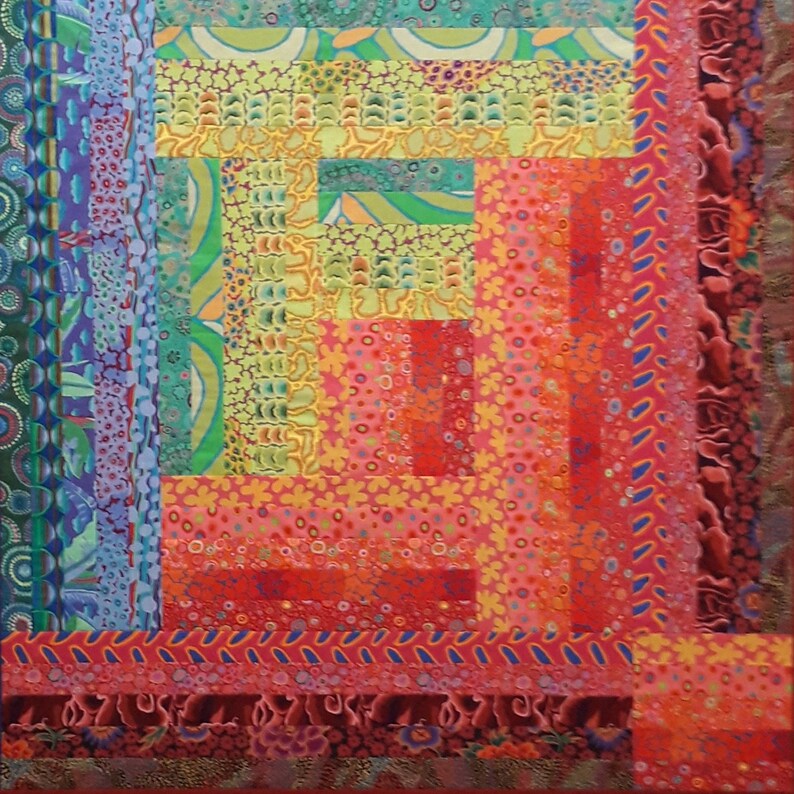 May include: A colorful quilt with a patchwork design featuring various shades of red, pink, yellow, green, and blue. The quilt is made up of different fabric squares sewn together to create a geometric pattern.