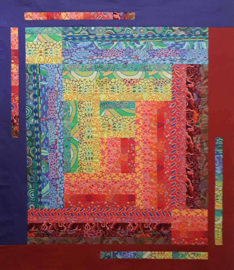 May include: A colorful quilt with a log cabin pattern. The quilt is made of various fabrics with different patterns and colors, including red, orange, yellow, green, blue, and purple.