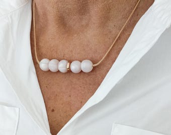 Silicone Nursing necklace for breastfeeding mum with gold and pearl effect beads.