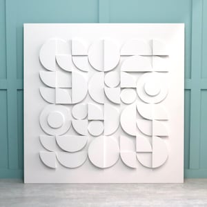 May include: White wall art with a geometric design made of circles and semi-circles. The design is raised and has a 3D effect.
