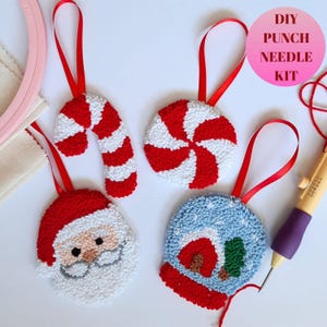May include: A DIY punch needle kit with four Christmas ornament designs: a candy cane, a peppermint swirl, a snowman, and Santa Claus. The kit includes a punch needle, yarn, and instructions.