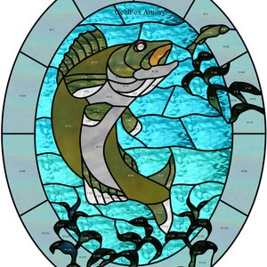 May include: A stained glass design of a fish jumping out of the water. The fish is green, gray, and white. The water is blue and turquoise. The design is in an oval shape and has a border of blue and gray glass. The text "GoldFox Artistry" is at the top of the design.
