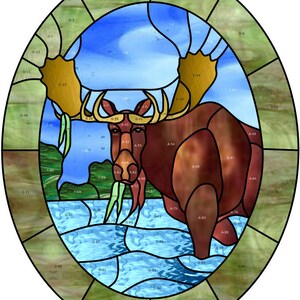 May include: A stained glass window depicting a brown moose standing in a blue lake with green reeds. The moose has large antlers and is facing the viewer. The window is surrounded by a green border.