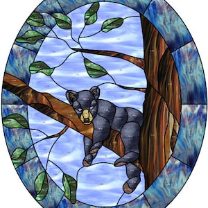 May include: A stained glass window design featuring a black bear sleeping in a tree with blue, green, and brown glass pieces.