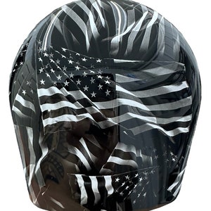 May include: A black and white helmet with an American flag design. The helmet is covered in a pattern of overlapping flags, with the stars and stripes visible.