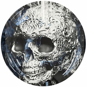 May include: A black and white image of a skull with intricate details. The skull is surrounded by a blue and white background.