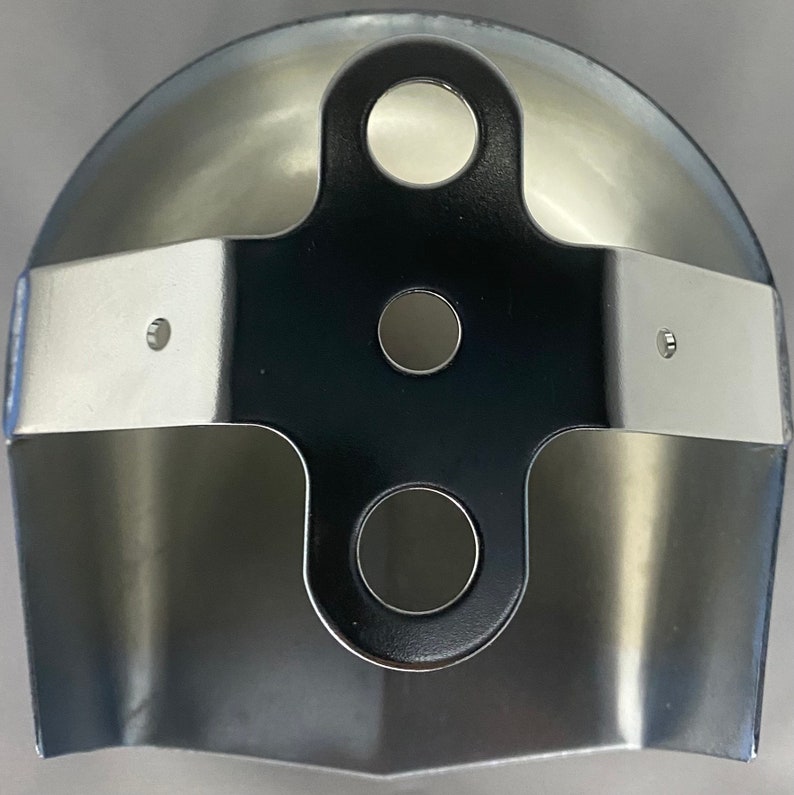 May include: A metallic, semi-circular component featuring a central black cross-shaped bracket. The bracket has three circular holes and is secured to the curved, polished silver-toned metal body with two small rivets on each side.