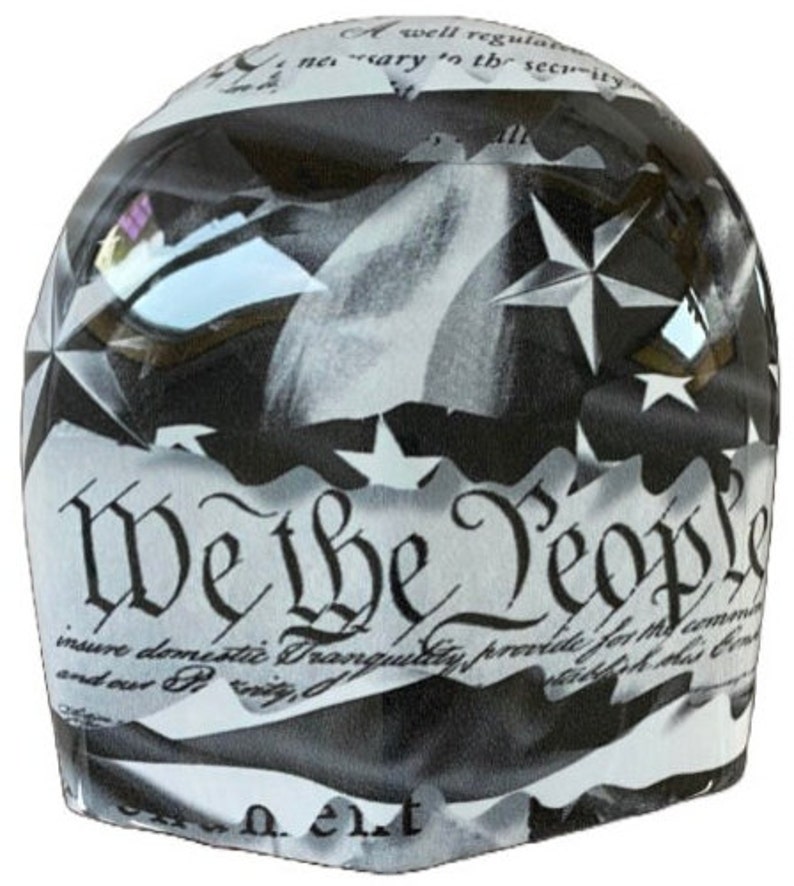 May include: A rounded, dome-shaped object featuring a black and white graphic print of the United States Constitution. The text "We the People" is prominently displayed in a decorative script font, accompanied by star motifs and flag imagery.