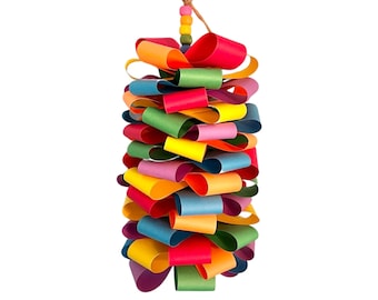 May include: A colorful paper streamer with a rainbow of colors, including red, orange, yellow, green, blue, purple, and pink. The streamer is made of paper and is tied together with a string. It is hanging from the ceiling.