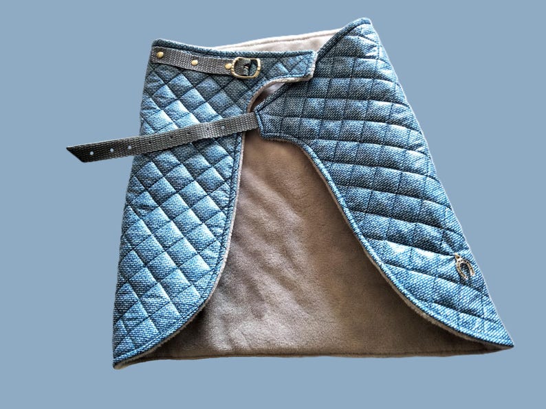 May include: A quilted denim skirt with a brown fleece lining and a black adjustable belt with a gold buckle.