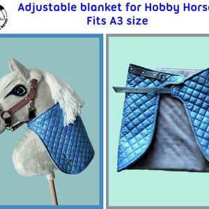 May include: Blue quilted adjustable blanket for a hobby horse. The blanket is designed to fit a hobby horse that is A3 size. The blanket has a strap with a buckle to adjust the fit.