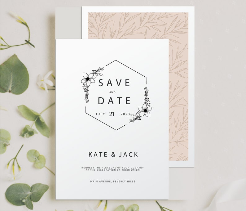 May include: A white save the date card with a black hexagonal frame with floral accents. The text reads "Save the Date" with the date "July 21, 2023". Below the date, it reads "Kate & Jack" and includes the text "Request the pleasure of your company at the celebration of their union. Main Avenue, Beverly Hills."
