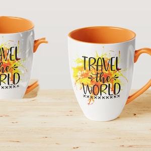 May include: Two white ceramic mugs with orange rims. Both mugs feature a watercolor-style yellow and orange splatter design. The text "Travel the World" is printed in black on both mugs.