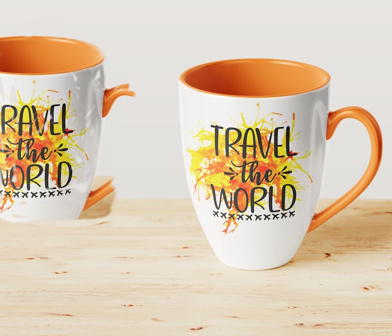 May include: Two white ceramic mugs with orange rims. Both mugs feature a watercolor-style yellow and orange splatter design. The text "Travel the World" is printed in black on both mugs.