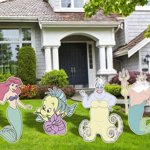 May include: A set of five cardboard cutouts featuring characters from the Disney movie The Little Mermaid. The characters include Ariel, Prince Eric, Flounder, Ursula, and King Triton. The cutouts are printed in bright colors and are perfect for decorating a party or event.