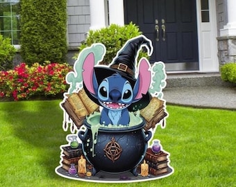 May include: A yard decoration featuring Stitch from Lilo & Stitch as a witch. Stitch is in a cauldron with books, candles, and potion bottles. The decoration is on a green lawn in front of a house.