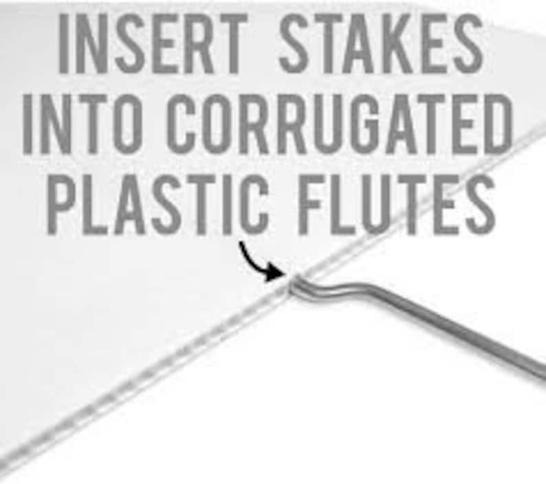 May include: A white corrugated plastic sheet with a metal stake being inserted into the flutes. The text INSERT STAKES INTO CORRUGATED PLASTIC FLUTES is printed in gray capital letters above the stake, with a black arrow pointing to the insertion point.