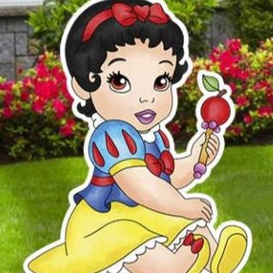 May include: A cartoon illustration of a baby character with black hair, a red headband with a bow, and a blue and yellow dress. The character is sitting down and holding a red apple-shaped rattle with a green leaf on a light brown handle.