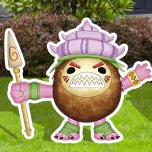 May include: A colorful cartoon cutout of a coconut-like character with a fierce expression. The character has a brown body, pink limbs, and a purple hat. It holds a spear and stands on green grass.