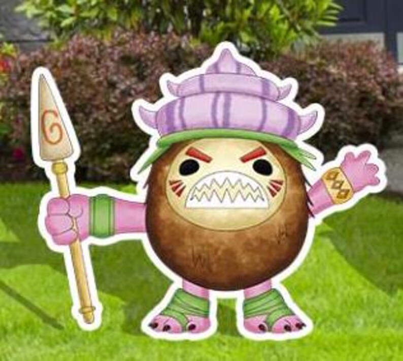 May include: A colorful cartoon cutout of a coconut-like character with a fierce expression. The character has a brown body, pink limbs, and a purple hat. It holds a spear and stands on green grass.