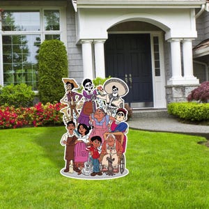 May include: A colorful cardboard cutout of the characters from the animated movie Coco. The characters are standing in front of a house with a green lawn. The characters include Miguel, Hector, Mama Imelda, Dante, and others.