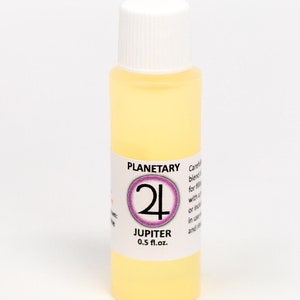 May include: A small, clear glass bottle with a white cap and a label that says "Planetary 24 Jupiter 0.5 fl. oz."