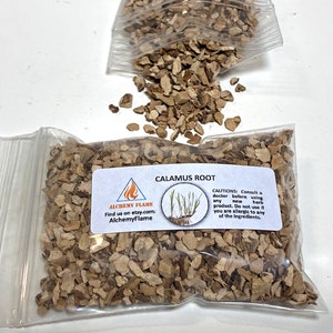 May include: A clear plastic bag filled with dried calamus root pieces. The bag has a white label with the text "ALCHEMY FLAME" and "CALAMUS ROOT". The label also includes a small illustration of a calamus plant and instructions for use.