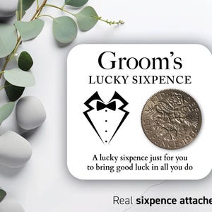 May include: A white card with the text "Groom's LUCKY SIXPENCE" and a tuxedo graphic. A vintage sixpence coin is attached. The text "A lucky sixpence just for you to bring good luck in all you do" is also included.