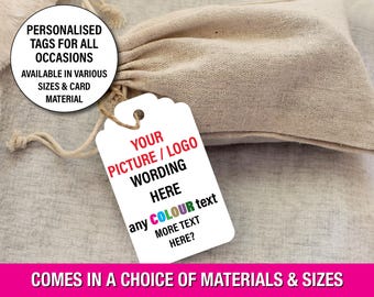 May include: A white tag with a scalloped edge, attached to a beige drawstring bag. The tag has text that reads "YOUR PICTURE/LOGO WORDING HERE" and "any COLOUR text MORE TEXT HERE?" A circular graphic says "PERSONALISED TAGS FOR ALL OCCASIONS".