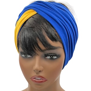 May include: A blue and yellow turban-style headband. The headband is made of a soft, stretchy fabric and is designed to be worn on the head. The blue section wraps around the head, while the yellow section crosses over the forehead.
