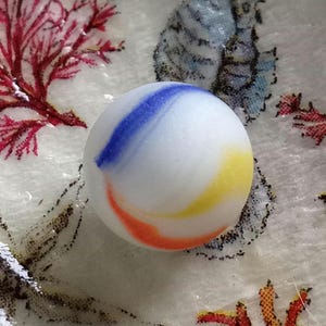 Very unique white blue, red and yellow swirl opaque Seaglass marble perfectly weathered by the ocean