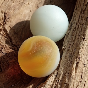 Yellow  and white sea glass marble perfectly weathered by the seas of Nova Scotia, Canada