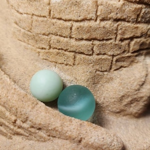 Beautiful sage green sea glass marble perfectly weathered by the ocean found on the beaches of Nova Scotia