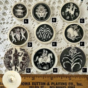 May include: Nine round, white, ceramic buttons with black and white designs. The designs include a pagoda, a woman's face, a cupid riding a horse, two cupids with grapes, a swirl design, a ship, a man playing a flute, a man and woman riding a horse, and a flower.