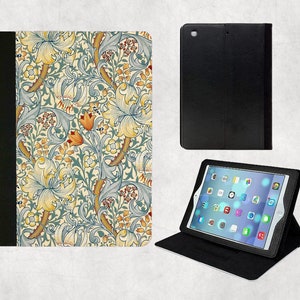 May include: A black iPad case with a floral pattern. The case has a stand that can be used to prop up the iPad.
