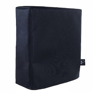 May include: A black rectangular cover, likely for an electronic device, with a textured surface. The cover has a stitched seam down the side and a small tag on the lower right corner.