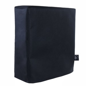 May include: Black fabric cover for a speaker or electronic device. The cover has a small tag with the word "Pro" on it.