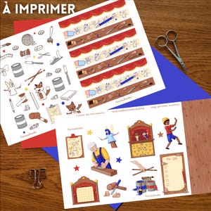 May include: Sheets of stickers with illustrations of puppets, tools, and theater elements. The stickers include text in French, and are on a wooden surface with red and blue paper accents. A pair of scissors is also visible.