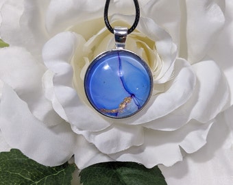 Round abstract alcohol ink pendant in blue with gold accent. Original wearable art pendant.