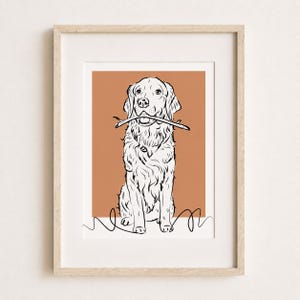 Puede incluir: Una l&aacute;mina de arte enmarcada con un dibujo lineal en blanco y negro de un perro golden retriever que sostiene un palo en la boca. El perro est&aacute; centrado sobre un fondo rectangular de color terracota con una l&iacute;nea negra simple en la base.