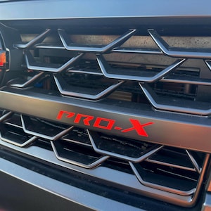 Grille Decal Accent by LUDesignsNY custom created and designed to fit a 2025-26 Nissan Frontier Pro-X and Pro-4X w/FREE LIFETIME REPLACEMENT